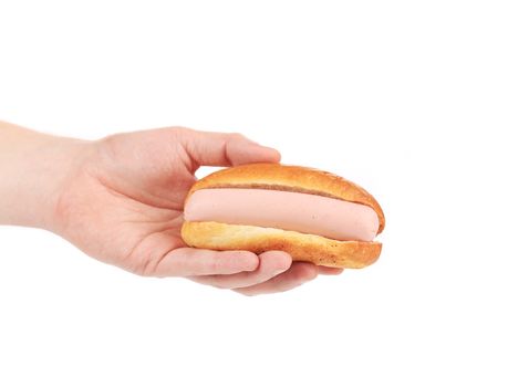 Man hand holding tasty hot dog. Isolated on a white background.