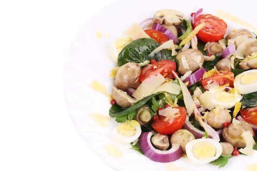 Mushroom salad with tomatoes and quail eggs. Isolated on a white background.