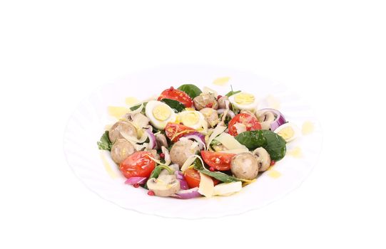 Mushroom salad with tomatoes and quail eggs. Isolated on a white background.