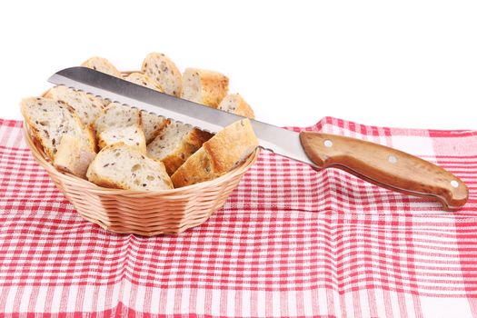 Basket with sliced bread and knife. Isolated on a white background.