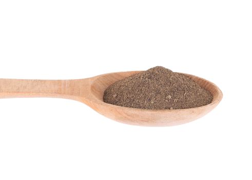 Wooden spoon with milled black pepper. Isolated on a white background.