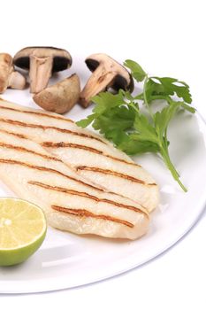 Grilled fish fillet with mushrooms. Isolated on a white background.