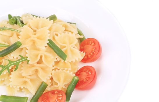 Delicious italian pasta farfalle with tomatoes. Isolated on a white background.