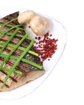 Grilled fish fillet with vegetables. Isolated on a white background.