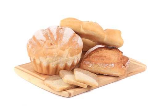 Bread on cutting board. Isolated on a white background.