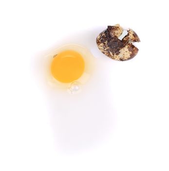 Broken quail egg. Isolated on a white background.