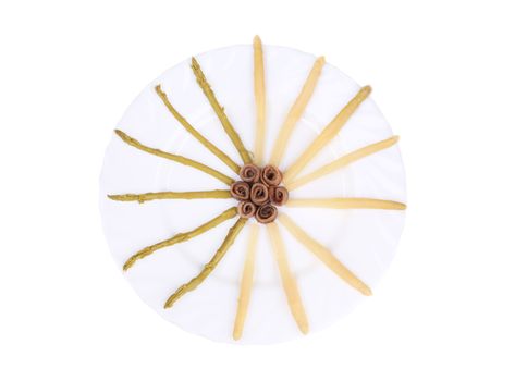 Asparagus and anchovies. Isolated on a white background.