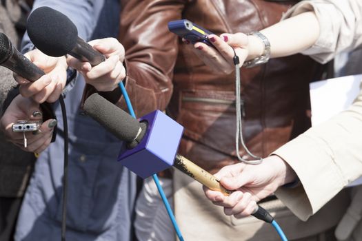 A journalist is making an interview with a microphone