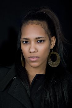 young beautiful woman close up portrait, on black background