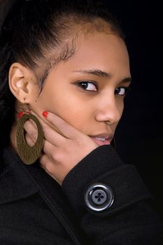 young beautiful woman close up portrait, on black background