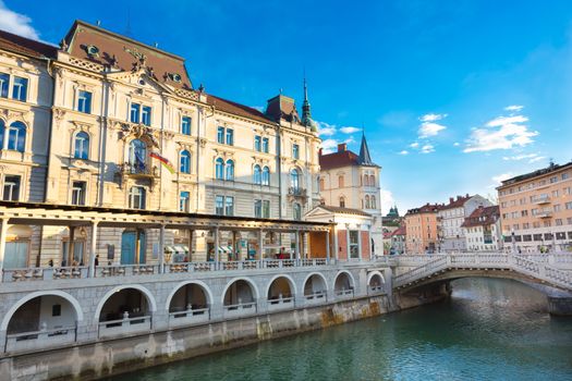 Ljubljana, Slovenia, Europe - Ljubljanica River, Triple bridge - Tromostovje and Central Market designed by famous architect Joze Plecnik shot in sunset.