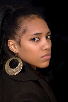 young beautiful woman close up portrait, on black background