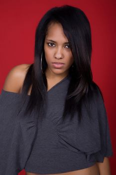 young casual woman portrait in a red background