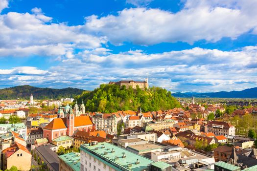 Panorama of the vibrant Slovenian capital Ljubljana in afternoon sun.