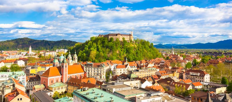 Panorama of the vibrant Slovenian capital Ljubljana in afternoon sun.