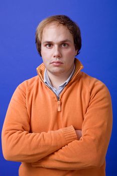 an young man portrait over a blue background