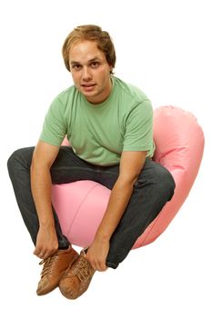 young casual man seated in a small sofa