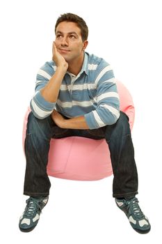 young casual man seated in a small sofa