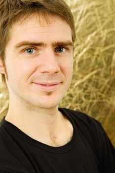 young casual man against a golden background