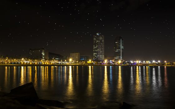 View of the promenade of Barcelona by night from the sea