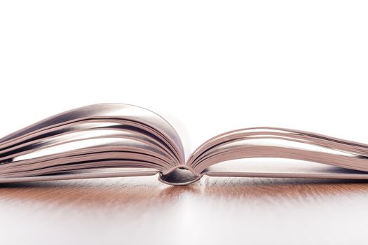 open book with white pages on wooden table