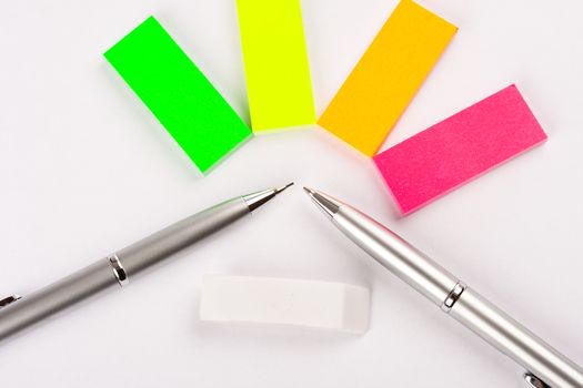 two pens with small different color post-its