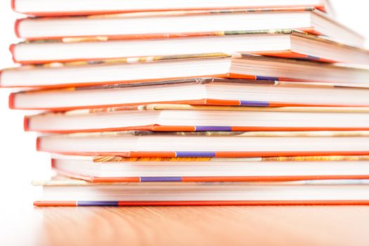 Pile of different books put on a wooden table