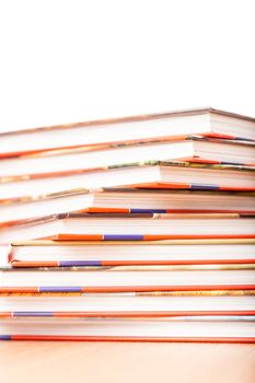 Pile of different books put on a wooden table