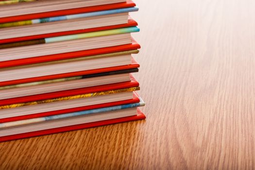 Pile of different books put on a wooden table