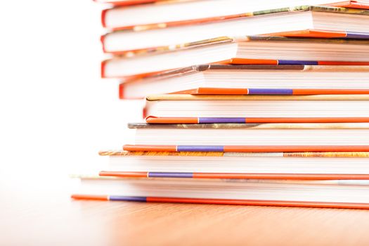 Pile of different books put on a wooden table