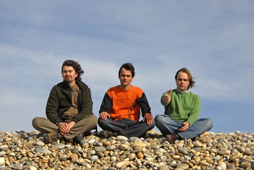 three casual young men at the beach