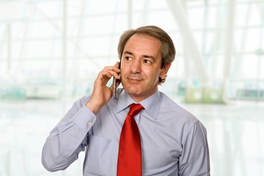 mature man on the phone at the office