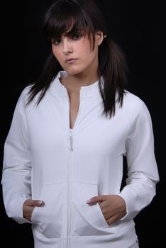 Young woman posing in black background in casual clothes