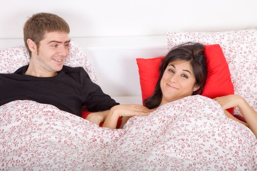 young couple in bed, studio picture