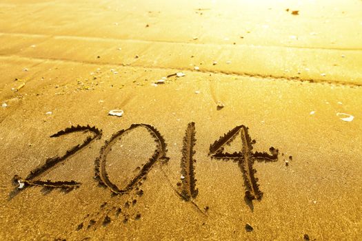 New year 2014 digits on ocean beach sand