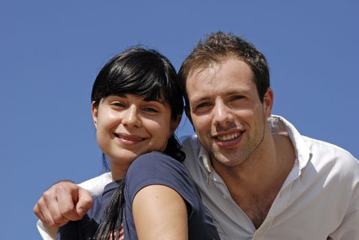 young couple portrait with the sky as background