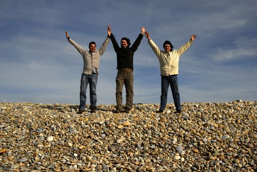 three casual young men at the beach