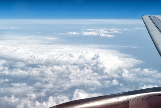 airplane wings in the blue clouds