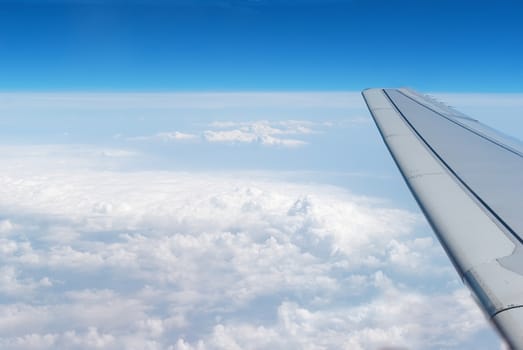 airplane wings in the blue clouds