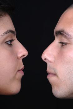 young couple together portrait on black background