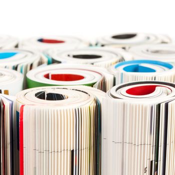 Stack of color magazines on white background
