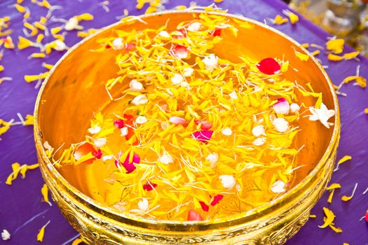 Water in bowl mixed with perfume and  flowers for Songkran festival, Thailand