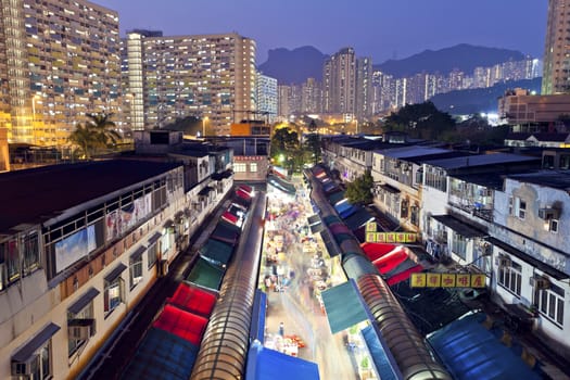 HONG KONG - FEB 9, Ngau Chi Wan Market with many booths and local people walking through in Hong Kong on 9 Feburary, 2014. It is one of the busiest local markets at night in the territory.