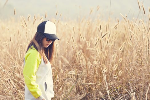 Asian woman lonely in wheat farm