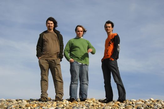 three casual young men at the beach