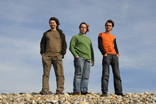 three casual young men at the beach