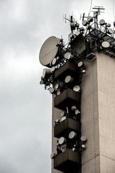 Large Communications tower standing against gloomy sky