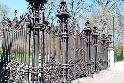 Iron railing around small park garden in London, England