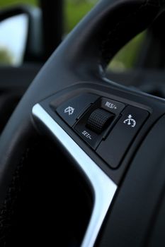 speed limitation and cruise control buttons on a steering wheel in modern car
