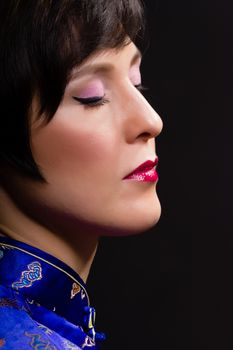 Beautiful young woman. Japanese makeup. Portrait on black background